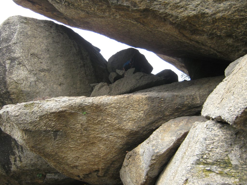 Boy hiding among boulders