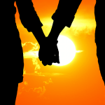 lovers holding hands in sunset